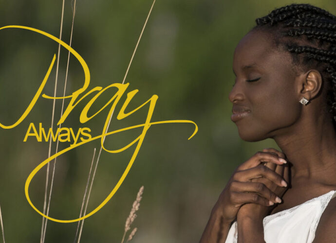 A beautiful african american woman praying and looking serene.