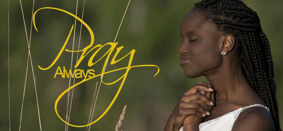 A beautiful african american woman praying and looking serene.