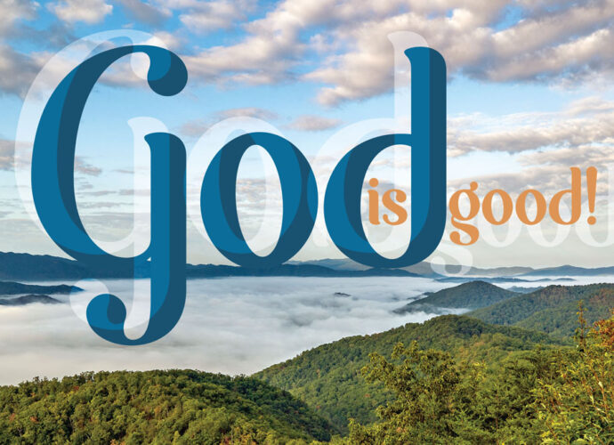 A beautiful riverside in the distance with the words, God is Good, written in the foreground.