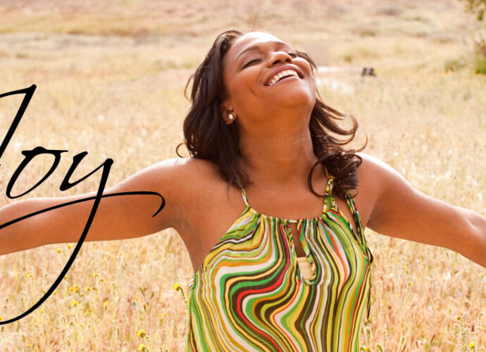 A beautiful woman, arms wide open, embracing joy