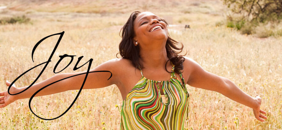 A beautiful woman, arms wide open, embracing joy