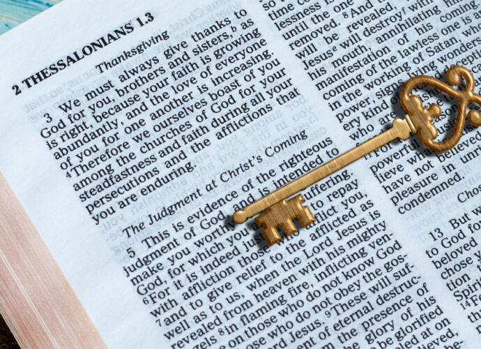 an open bible with a key on top symbolizing that God's Word is the key to life