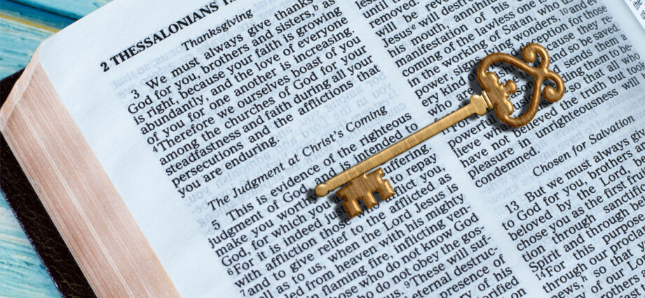 an open bible with a key on top symbolizing that God's Word is the key to life