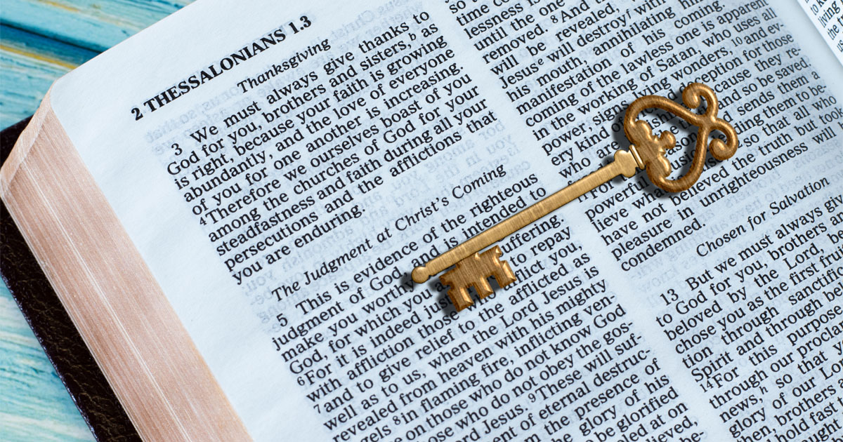 an open bible with a key on top symbolizing that God's Word is the key to life