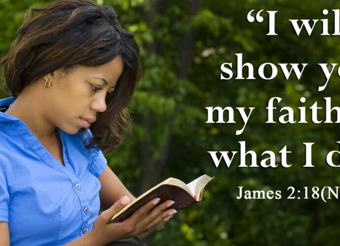Beautiful young woman in the park reading the bible. John 2:18 NIV in the foreground.