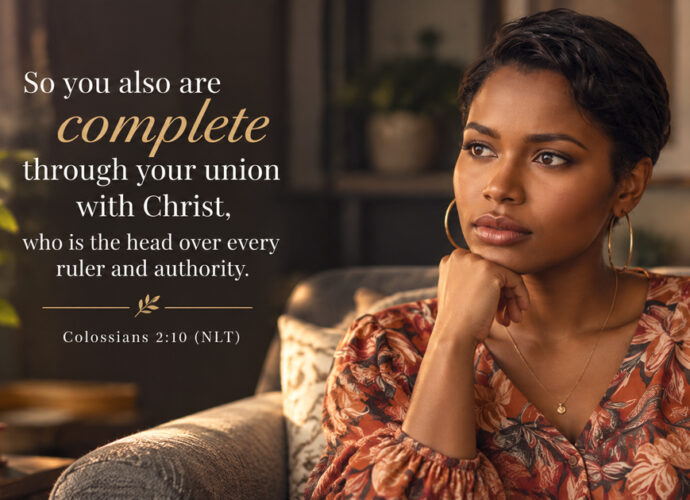 Woman sitting thoughtfully in a warmly lit room beside Colossians 2:10 NLT, emphasizing that believers are complete through their union with Christ.